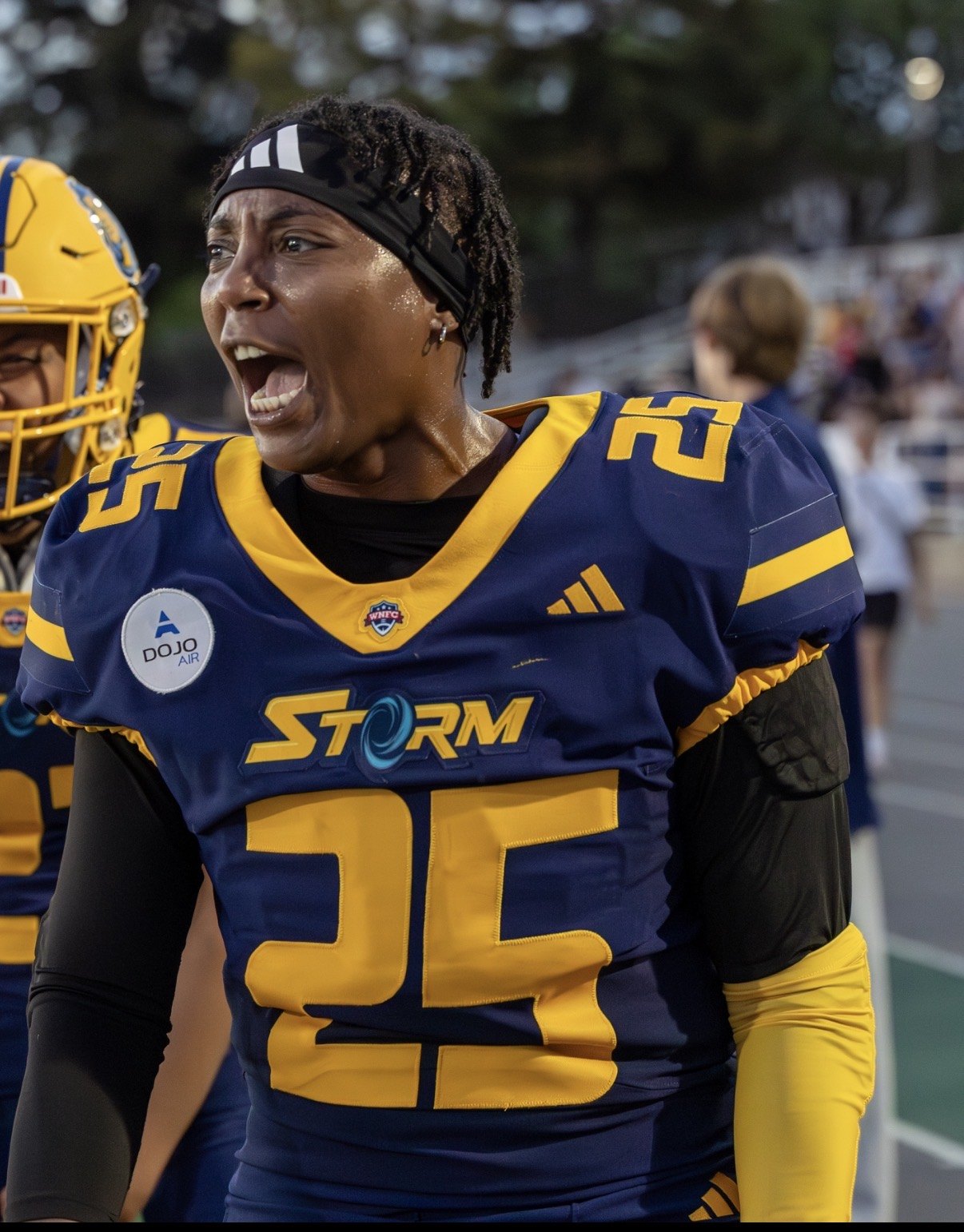 Mo Bennett on the Golden State Storm sideline in blue and gold, shouting toward the field